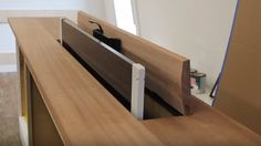 a close up of a wooden desk with a mirror on it's back wall