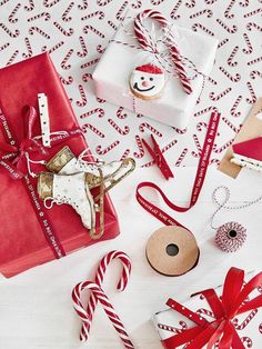 presents wrapped in red and white paper with candy canes