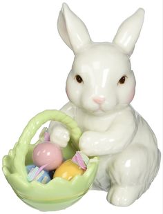 a ceramic bunny sitting next to a basket filled with eggs