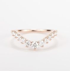 a rose gold ring with three diamonds on it