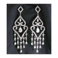 "These sparkling chandelier earrings have dozens of faceted cubic zirconia in round, pear and marquise shapes dangling from an open diamond-shape top finishing with five dangling fringes. Each earring is 3 1/8\" high and just over 1\" wide.  The stones are all set open-backed to maximize the brilliant reflections.  And these ARE brilliant; truly, much prettier than in the photos. The posts have vinyl clutches.  There are no marks on the earrings but they are very well made. Condition is excellen Silver Pear-shaped Chandelier Earrings For Evening, Elegant Pear-shaped Chandelier Earrings For Party, Cubic Zirconia Drop Chandelier Earrings, Dazzling Diamond Teardrop Chandelier Earrings, Diamond White Teardrop Chandelier Earrings With Diamond Accents, Dazzling Crystal Drop Chandelier Earrings, Glamorous Cubic Zirconia Drop Chandelier Earrings, Crystal Pear-shaped Chandelier Earrings For Parties, Evening Teardrop Chandelier Earrings With Sparkling Stones