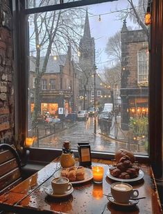 two plates of food on a table in front of a window with a view of the street