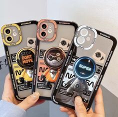 three cell phones with different buttons on them are being held by someone's hands