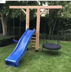 a wooden swing set with a blue slide and black trampoline in the back yard