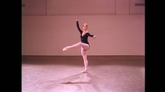 a ballerina in black leotard and white tights is doing a ballet move