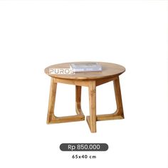 a round wooden table sitting on top of a white floor