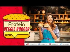 a woman holding a sandwich in front of a sign that says protein veggie burgerer