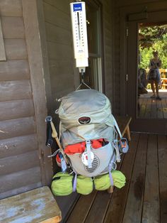 a back pack sitting on top of a wooden porch