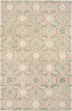 a pink and green rug with an ornate design on the bottom, in different colors