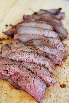 sliced meat on a cutting board with a fork