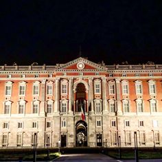 an old building lit up at night time