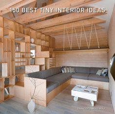 a living room filled with lots of wooden shelves next to a couch and coffee table