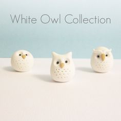 three ceramic owls sitting next to each other