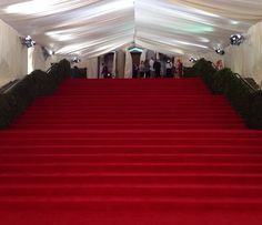 red carpeted steps leading up to a white tent