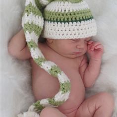 a newborn baby wearing a crocheted hat