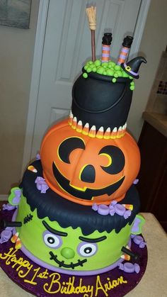 a three tiered cake decorated with halloween decorations