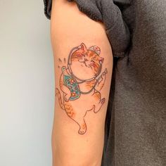 a woman with a cat tattoo on her arm