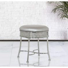 the stool has a silver cushion on it