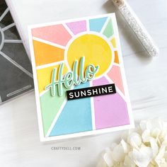 a card with the words hello sunshine on it next to some flowers and a pen