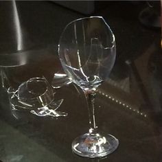 two wine glasses sitting on top of a table