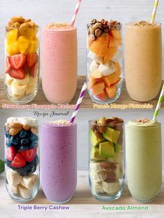 four different smoothies in glass cups with strawberries, bananas, and kiwis