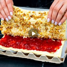 two hands on top of an uncooked pastry with crumbled toppings