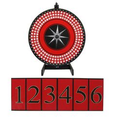 a red and black clock sitting on top of a wooden block with numbers below it