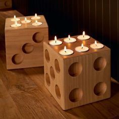 candles are lit on wooden blocks with holes in them