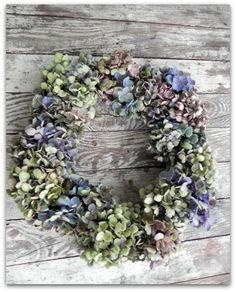 a wreath with purple and green flowers on it