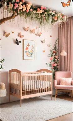 a baby's room with pink furniture and flowers on the wall hanging from the ceiling