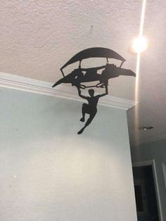 a man is hanging upside down from the ceiling