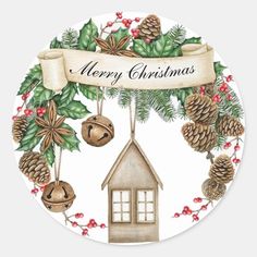 a christmas wreath with pine cones, bells and holly leaves on the front of a round sticker