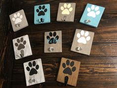 dog paw magnets on wooden boards with the word self spelled in blue and white