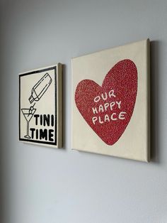 two paintings on the wall that say our happy place and our own time with a red heart