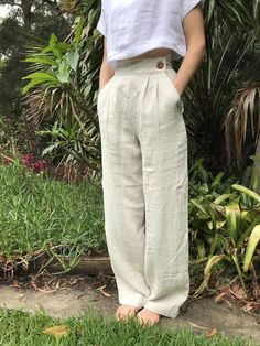 "LINEN HIGH WAISTED STRAIGHT LEG TROUSERS - CUSTOM ITEM** High waisted vintage style trousers. Tailored at the waist, pleated at the front, two pockets at the hips, and darts at the back of the waist for a defined fit. Pocket opening button and press stud closure. Wide/straight leg finishing below the ankle. Tailored to your height FARGELAND is an independent, female-owned business. All of my clothing is designed and handmade by me in my art studio in Bulli, Australia. Just south of Sydney. When Cream Wide Leg Trousers, Pants Custom, Fashion Minimal, Straight Leg Trousers, Black Linen, High Waisted Trousers, Minimal Fashion, Linen Pants, Slow Fashion