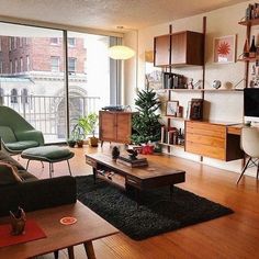 a living room filled with furniture and a flat screen tv sitting on top of a wooden table