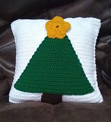 a crochet christmas tree pillow on a brown leather chair with the text, free pattern