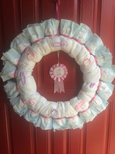 a wreath made out of diapers hanging on a door