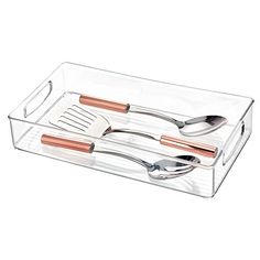 two utensils in a clear container with copper handles