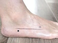 a person's foot with a small black dot on it