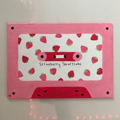 a pink and white card with strawberries on it