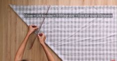 a woman is measuring the length of a piece of fabric