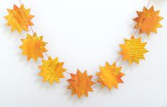 an orange and yellow star garland on a white background