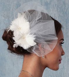 a woman with a veil and flower in her hair