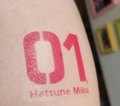 a close up of a person's arm with the number one on it and pink lipstick