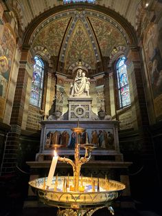 an ornate alter in a church with stained glass windows