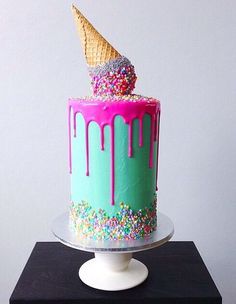 a cake with sprinkles and an ice cream cone on top