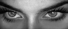 the eyes of a woman with long lashes and false eyelashes are shown in black and white