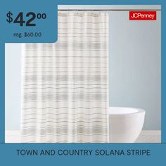 a white shower curtain sitting next to a toilet