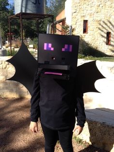 a person in a costume made to look like a bat with purple squares on it